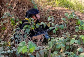 A Thai soldier takes cover near the 2nd Thailand-Myanmar Friendship Bridge during fighting on the Myanmar side between the Karen National Liberation Army (KNLA) and Myanmar's troops, which continues near the Thailand-Myanmar border, in Mae Sot, Tak Province,  Thailand, April 20, 2024.
