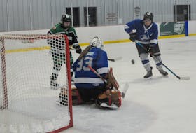 Mount Pearl Huskies goaltender Katie Winsor kicks-out a shot on net by O’Donel Patriots Maggie Carew, left, in first-period action of their playoff game in the 2024 Royal Newfoundland Regiment Memorial Hockey Tournament at the Paradise Double Ice Complex on Saturday, April 20, 2024. O’Donel won 2-0 with goalie Jennifer Murphy registering the shut-out. At right to clear the puck away is the Huskie’s Norah Fudge.
-Photo by Joe Gibbons/The Telegram
