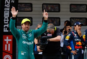 Formula One F1 - Chinese Grand Prix - Shanghai International Circuit, Shanghai, China - April 20, 2024 Aston Martin's Fernando Alonso celebrates after finishing third in qualifying as second placed Red Bull's Sergio Perez looks on