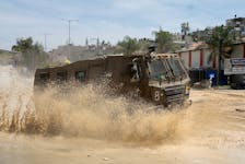 An Israeli military vehicle maneuvers during an Israeli raid, at Nour Shams camp, in Tulkarm, in the Israeli-occupied West Bank, April 20, 2024.