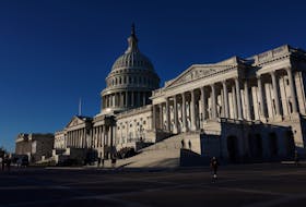 People walk past the U.S. Capitol building in Washington, U.S., January 11, 2024.