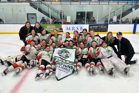 The Charlottetown-based Central Storm celebrate and pose for a team photo after winning the 2024 Atlantic under-15 AAA female hockey championship in North Rustico on April 21. The Storm defeated Nova Scotia’s Metro Force West Citadels 7-3 in the gold-medal game. Contributed