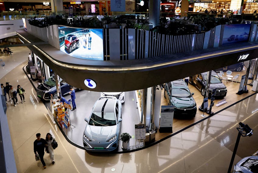 Electric vehicles are displayed at a shopping mall in Beijing, China, Nov. 3, 2023.