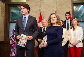 Canada's Prime Minister Justin Trudeau and Finance Minister Chrystia Freeland pose for a picture holding the 2024-25 budget, on Parliament Hill in Ottawa, Ontario, Canada, April 16, 2024. 