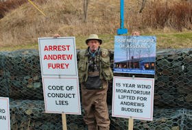 Mike Cooze was the demonstrating by himself on Apr. 22 in front of the RCMP Headquarters premises. Having spent over $400 on signs, he says he plans to tour the whole city with his demonstrations.