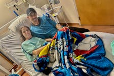 Covered by a super hero blanket belonging to her grandson, Kelly Doucet and her Steven count their blessings in her room at the Yarmouth Regional Hospital as she recovers from invasive group A strep, that also developed into necrotizing fasciitis, known as flesh-eating disease. TINA COMEAU