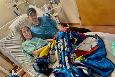 Covered by a super hero blanket belonging to her grandson, Kelly Doucet and her Steven count their blessings in her room at the Yarmouth Regional Hospital as she recovers from invasive group A strep, that also developed into necrotizing fasciitis, known as flesh-eating disease. TINA COMEAU