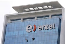 Workers clean the windows of the office building of Chilean telecommunications company Entel at the district of San Isidro in Lima, Peru September 1, 2018.