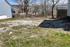 This vacant lot between two houses on Victoria Street in Whitney Pier is among the properties up for tax sale this week in Cape Breton Regional Municipality. BARB SWEET/CAPE BRETON POST