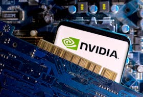 A smartphone with a displayed NVIDIA logo is placed on a computer motherboard in this illustration taken March 6, 2023.