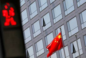 A Chinese national flag flutters outside the China Securities Regulatory Commission (CSRC) building on the Financial Street in Beijing, China July 9, 2021.