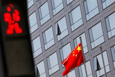 A Chinese national flag flutters outside the China Securities Regulatory Commission (CSRC) building on the Financial Street in Beijing, China July 9, 2021.
