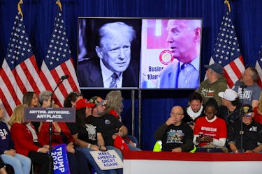 Pictures of U.S. President Joe Biden and Republican presidential candidate and former U.S. President Donald Trump are seen on a screen during a campaign rally for Trump in Green Bay, Wisconsin, U.S., April 2, 2024. 
