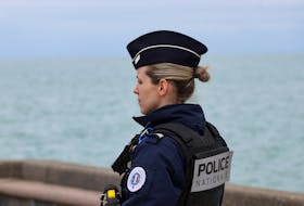 A police member looks on in Wimereux, near Calais, after migrants died in an attempt to cross the English Channel, in France, April 23, 2024.