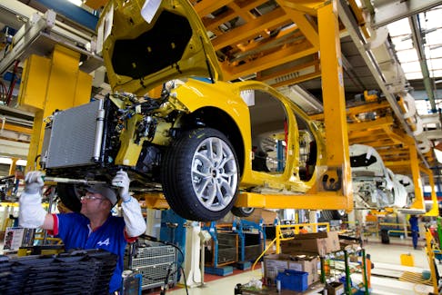 Employees of French carmaker Renault work on the Clio RS assembly line at Renault factory in Dieppe, France, September 1, 2015.