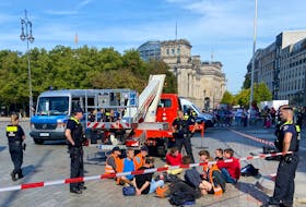 Police detain Last Generation ("Letzte Generation") climate activists after they threw paint on the columns of the Brandenburg Gate in Berlin, Germany, September 17, 2023.    