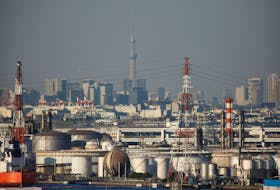 Chimneys of an industrial complex and Tokyo's skyline are seen from an observatory deck at an industrial port in Kawasaki, Japan, October 24, 2016.