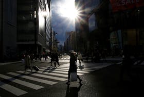People cross a road at a shopping district in Tokyo, Japan, January 23, 2017.