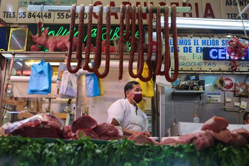 A butcher sells meat at a market in Mexico City, Mexico, January 19, 2022.