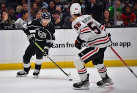 Apr 18, 2024; Los Angeles, California, USA; Los Angeles Kings right wing Adrian Kempe (9) moves in for a shot against the defense of Chicago Blackhawks defenseman Kevin Korchinski (55) during the overtime period at Crypto.com Arena. Mandatory Credit: Gary A. Vasquez-USA TODAY Sports