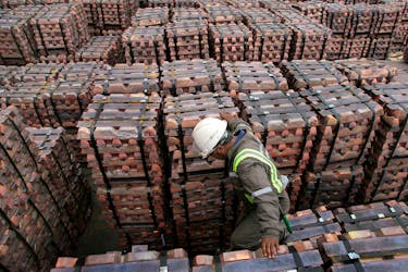 A port worker checks a shipment of copper that is to be exported to Asia in Valparaiso port, Chile August 21, 2006.    