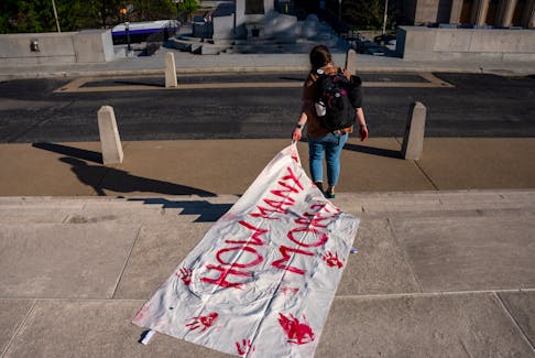A gun reform activists drags a body bag with the words “How Many more” down the steps of the Tennessee State Capitol building, following the House vote to adopt Senate Bill 1325 which would authorize teachers, principals, and school personnel to carry a concealed handgun on school grounds, in Nashville, Tennessee, U.S., April 23, 2024.  