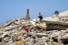 A Palestinian man sits on the rubble of a house destroyed by Israeli strikes, amid the ongoing conflict between Israel and Hamas, in the northern Gaza Strip, April 22, 2024.