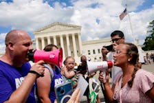 Abortion rights activists and counter protesters protest outside the U.S. Supreme Court on the first anniversary of the court ruling in the Dobbs v Women's Health Organization case, overturning the landmark Roe v Wade abortion decision, in Washington, U.S., June 24, 2023.