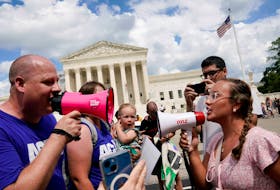 Abortion rights activists and counter protesters protest outside the U.S. Supreme Court on the first anniversary of the court ruling in the Dobbs v Women's Health Organization case, overturning the landmark Roe v Wade abortion decision, in Washington, U.S., June 24, 2023.