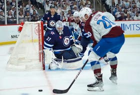 Connor Hellebuyck #37 of Winnipeg Jets defends his net against Ross Colton #20 of the Colorado Avalanche in Game One of the First Round of the 2024 Stanley Cup Playoffs at Canada Life Centre on April 21, 2024, in Winnipeg, Canada. (Photo by David Lipnowski)