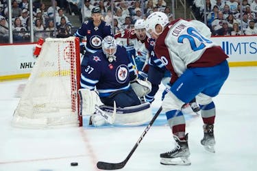 Connor Hellebuyck #37 of Winnipeg Jets defends his net against Ross Colton #20 of the Colorado Avalanche in Game One of the First Round of the 2024 Stanley Cup Playoffs at Canada Life Centre on April 21, 2024, in Winnipeg, Canada. (Photo by David Lipnowski)