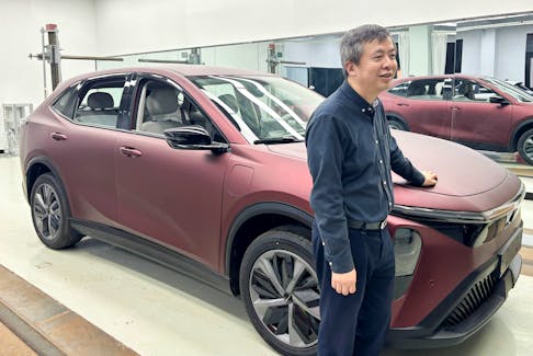 Wang Xun, founder and chairman of the auto design and engineering firm Launch Design, poses for a picture next to a prototype vehicle at the company's office in Shanghai, China April 18, 2024.