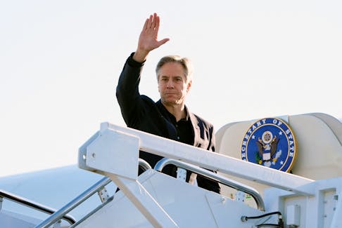U.S. Secretary of State Antony Blinken waves as he boards a plane, en route to China, at Andrews Air Force Base, Maryland, U.S., April 23, 2024. Mark Schiefelbein/Pool via REUTERS