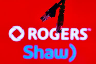 Ethernet cables are seen in front of Rogers and Shaw Communications logos in this illustration taken, July 8, 2022.