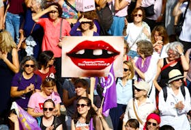 A protester carries a placard reading "Stop domestic abuse" at a demonstration during a women's strike (Frauenstreik) in Zurich, Switzerland June 14, 2019.