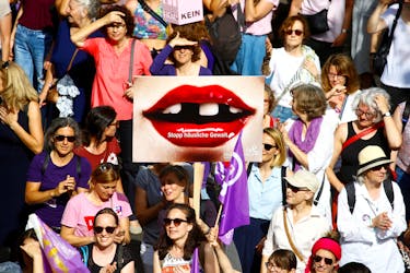 A protester carries a placard reading "Stop domestic abuse" at a demonstration during a women's strike (Frauenstreik) in Zurich, Switzerland June 14, 2019.