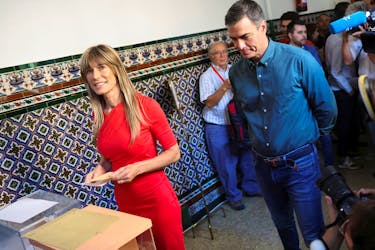 Spain's Socialist leader and Prime Minister Pedro Sanchez looks on as his wife Begona Gomez votes during the general snap election in Madrid, Spain, July 23, 2023.