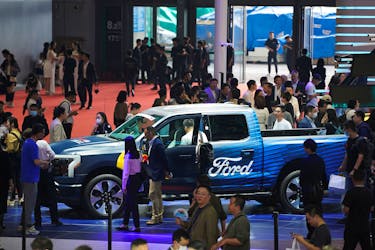 People visit a Ford booth at the Auto Shanghai show, in Shanghai, China April 18, 2023.