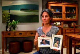 Rachel Goldberg, U.S.-Israeli mother of Hersh Goldberg Polin, which was taken hostage by Hamas militants into the Gaza Strip while attending a music festival in south Israel, holds photos of her son in their home in Jerusalem October 17, 2023