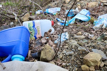 Discarded plastic containers litter sone brush in north-end Dartmouth Wednesday April 24,2024.

TIM KROCHAK PHOTO