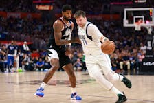 Apr 23, 2024; Los Angeles, California, USA; Dallas Mavericks guard Luka Doncic (77) dribbles the ball against Los Angeles Clippers forward Paul George (13) during the third quarter of game two of the first round for the 2024 NBA playoffs at Crypto.com Arena. Mandatory Credit: Kiyoshi Mio-USA TODAY Sports