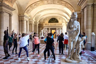 Members of staff of the Louvre Museum and agents of the Creteil choreographic center participate in a disco dance class as part of the dress rehearsal of 'Run in the Louvre', a series of sports visits to the Louvre, halfway between a visit guided, dance and sports training designed by French choreographer Mehdi Kerkouche at the Louvre Museum in Paris, France, April 23, 2024.