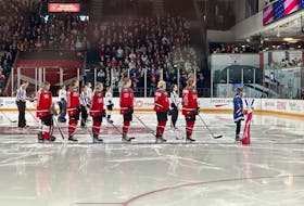 Isabelle Russell stands next to Ottawa forward Hayley Scamurra during the Apr. 20 PWHL game she spent as an anthem skater. Contributed photo