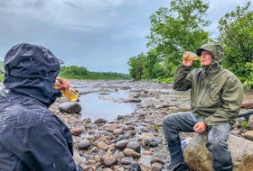 The boys have a brew on the river. The Simm's Flyweight, facing the camera, is a fantastic packable raincoat. - Paul Smith