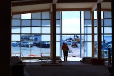 A worker carries out a window pane from what will become the entrance of the new Pictou Cultural Hub. According to Eric Stackhouse, the goal of the building is to create an in-between space between the Pictou harbourfront and the town's downtown core. He said he hopes the building to be a destination for people who live in Pictou and those looking to visit the town. ANGELA CAPOBIANCO