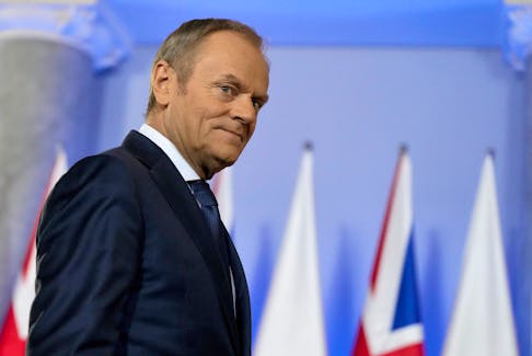 Polish Prime Minister Donald Tusk walks to meet British Prime Minister Rishi Sunak at the Chancellery of the Prime Minister in Warsaw, Poland, April, 23, 2024.