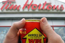 In this Saltwire file photo, a person rolls up the rim of their Tim Hortons cup to see if they are a winner or not, which was how the contest was run until 2021 when they decided to make it a digital-only game. SALTWIRE FILE