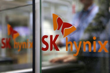 Employee walks past the logo of SK Hynix at its headquarters in Seongnam, South Korea, April 25, 2016.