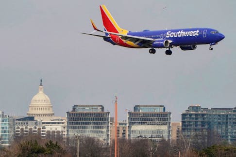 A Southwest Airlines aircraft flies past the U.S. Capitol before landing at Reagan National Airport in Arlington, Virginia, U.S., January 24, 2022.