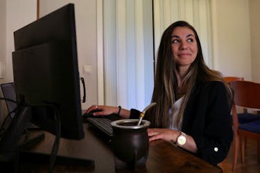 Argentinian postdoctoral researcher in distributed systems Marianela Morales poses for a portrait at her work station in her Madrid home, Spain, April 19, 2024.